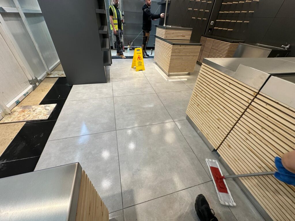 Final sparkle cleaning of tiled floors during post-construction cleaning in a commercial unit in Dublin