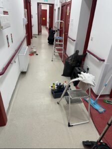 Modern new build kitchen being cleaned during construction handover with mop and cleaning bags