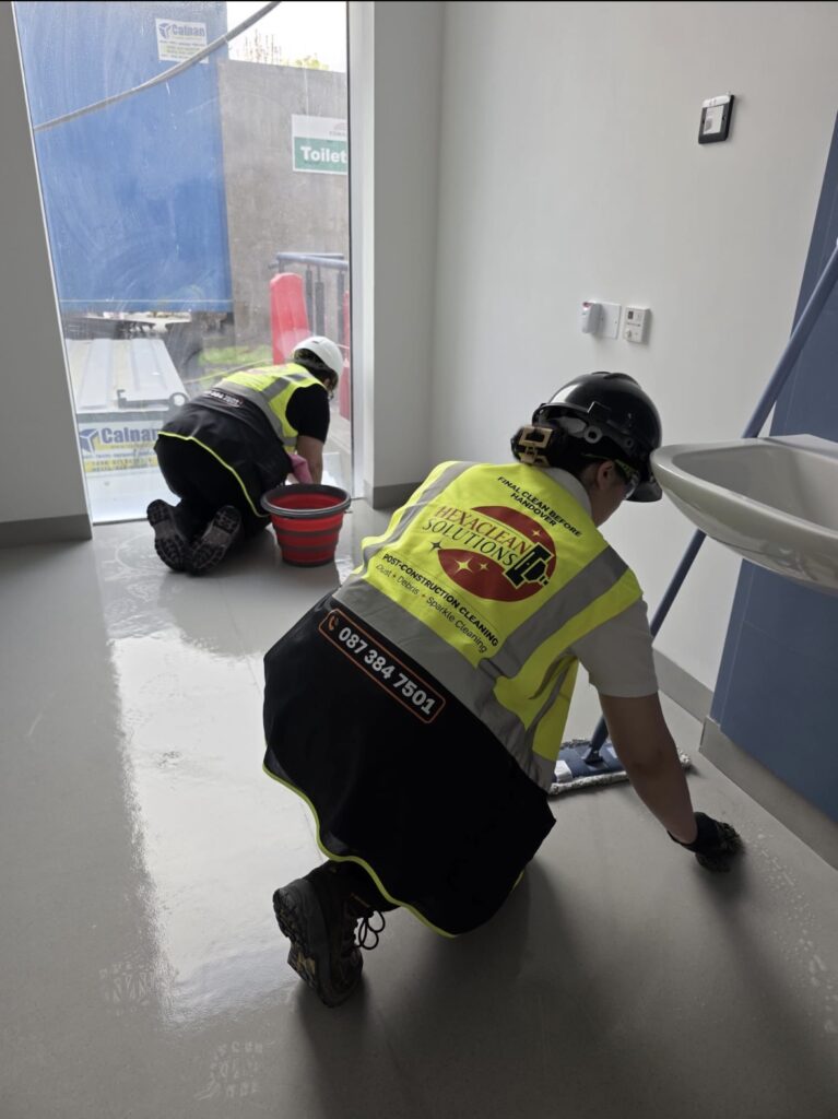 Two Hexaclean Solutions operatives in hard hats performing final clean in new-build facility Ireland