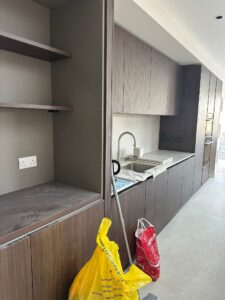Bright open plan kitchen with large tiles and skylights after post-construction sparkle clean