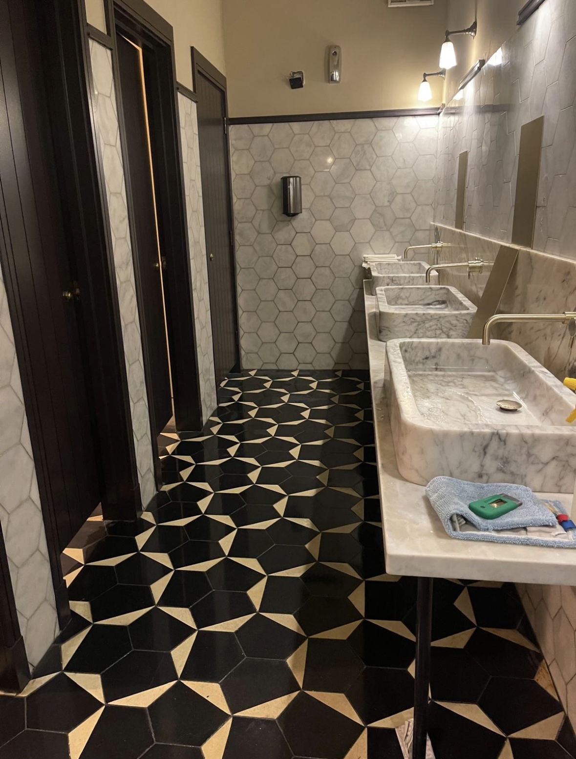 Hexaclean Solutions restaurant fit out cleaning Dublin — luxury bathroom with marble sinks and geometric floor tiles cleaned to handover standard