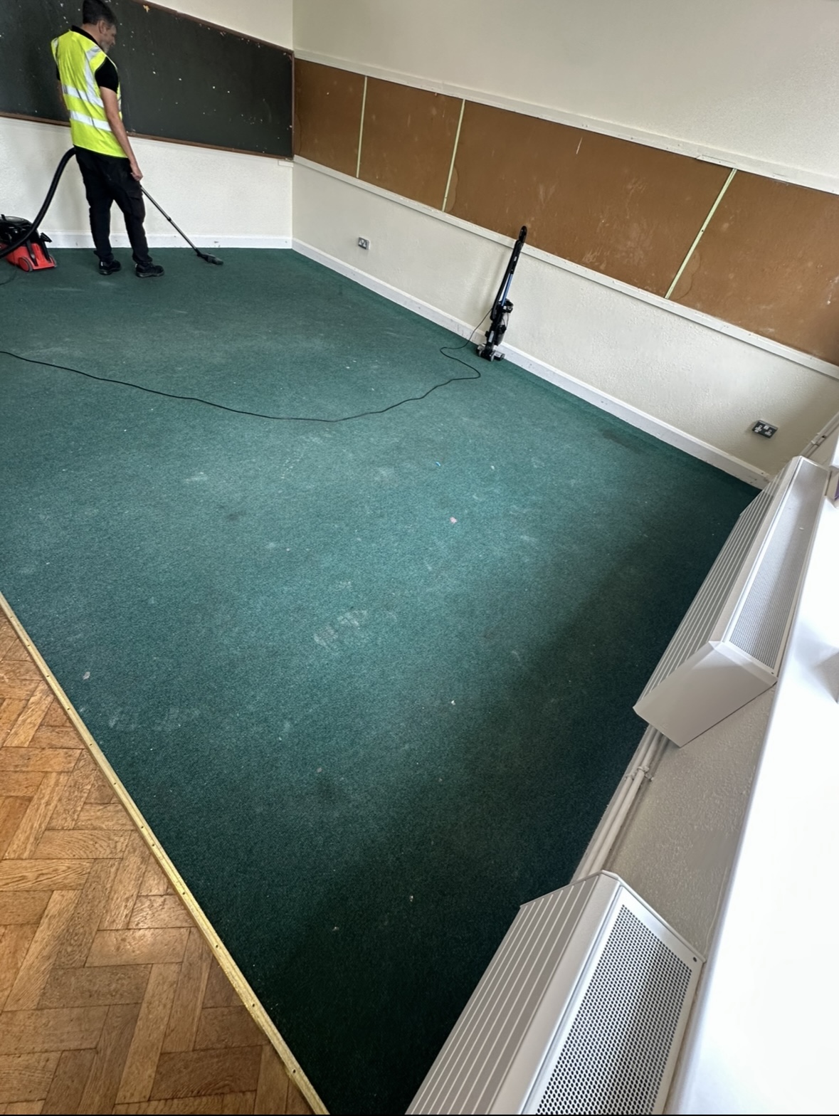 Hexaclean Solutions staff hoovering classroom carpet during school post construction clean