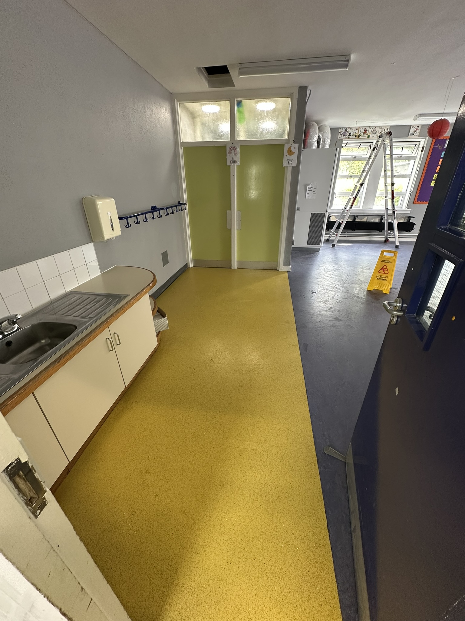 Classroom builders clean finished after school construction work