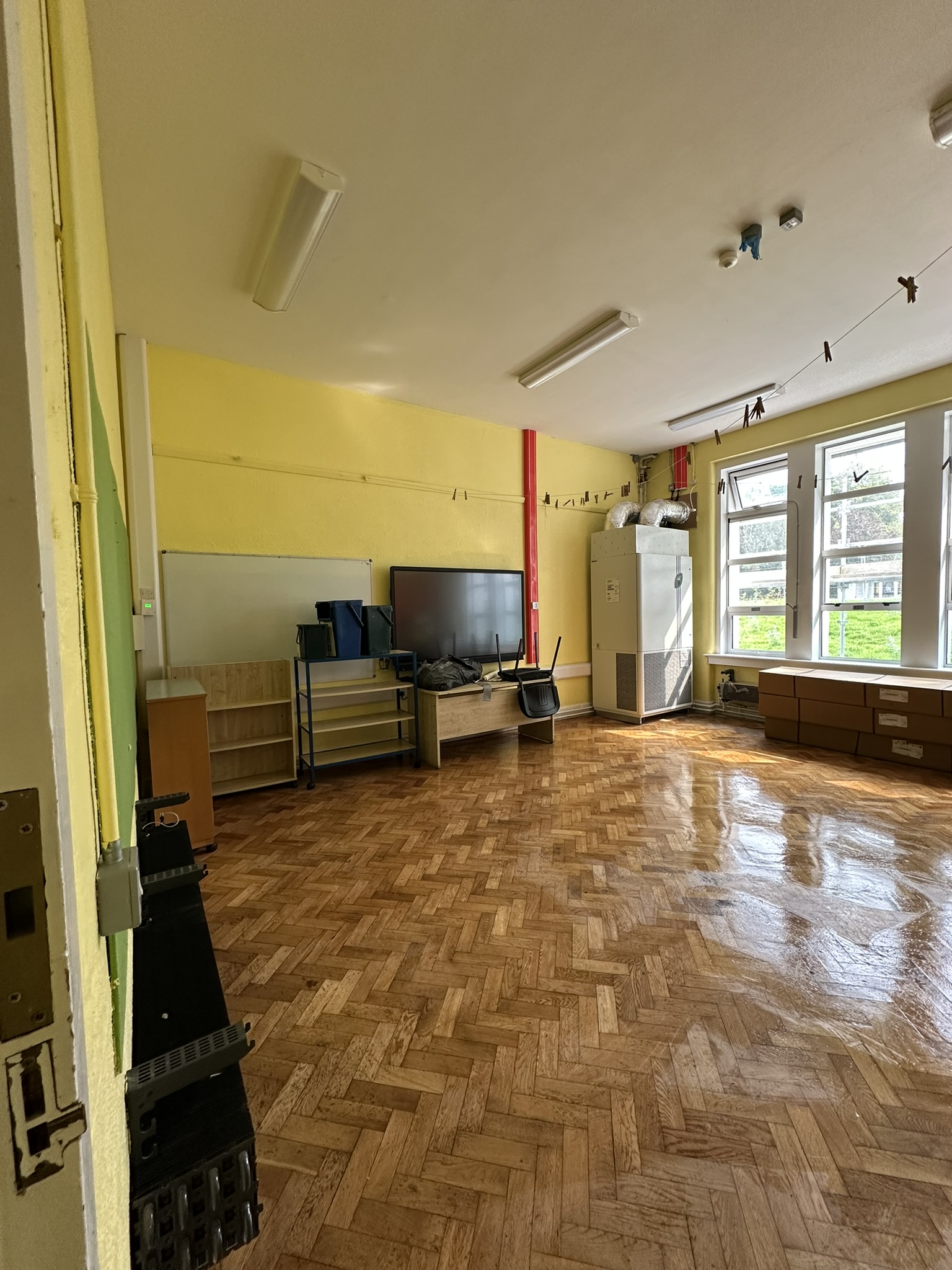 Freshly buffed classroom floor with glossy finish after school construction