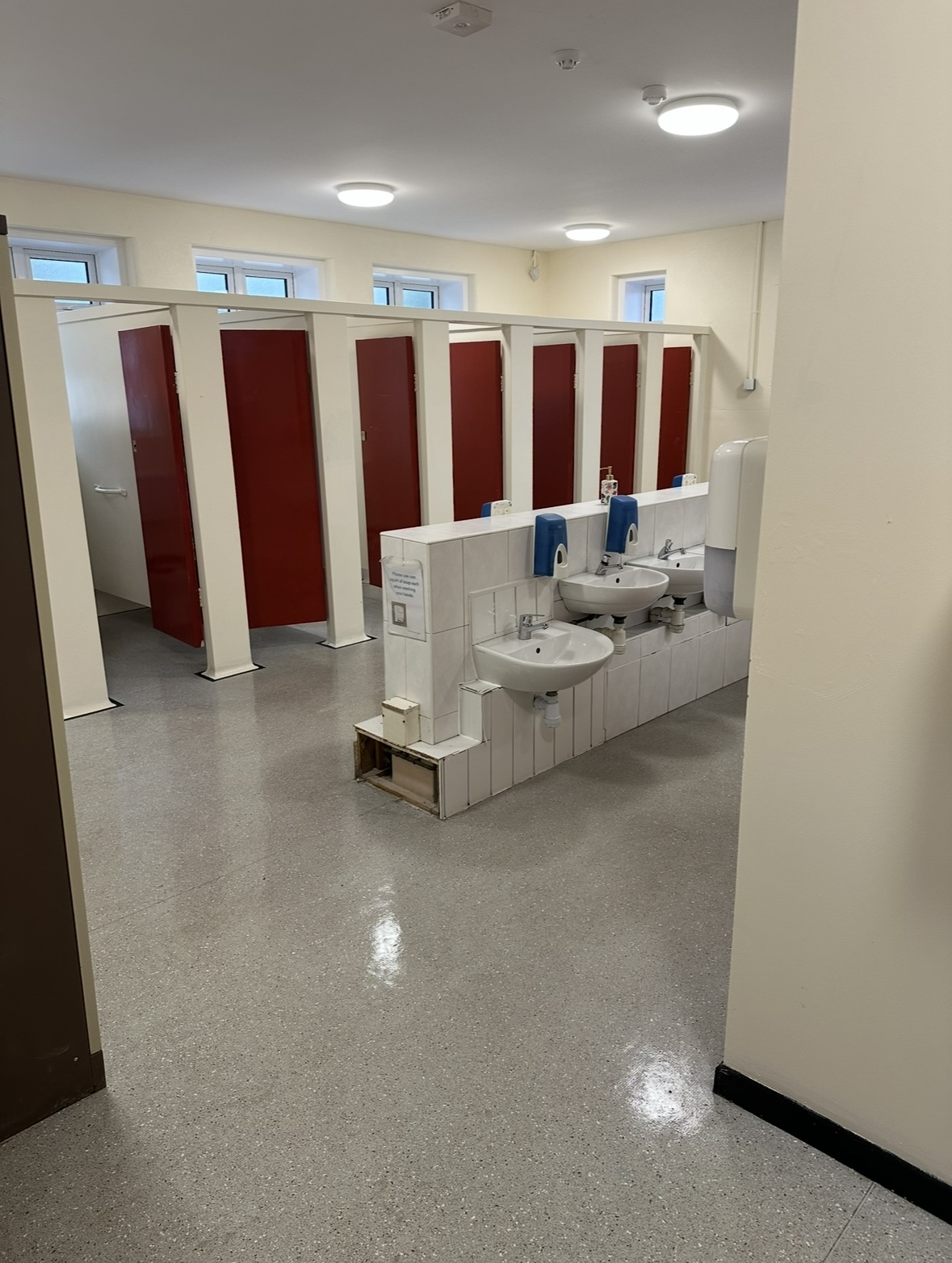 Large school toilet block with sparkling sinks and floors after deep clean