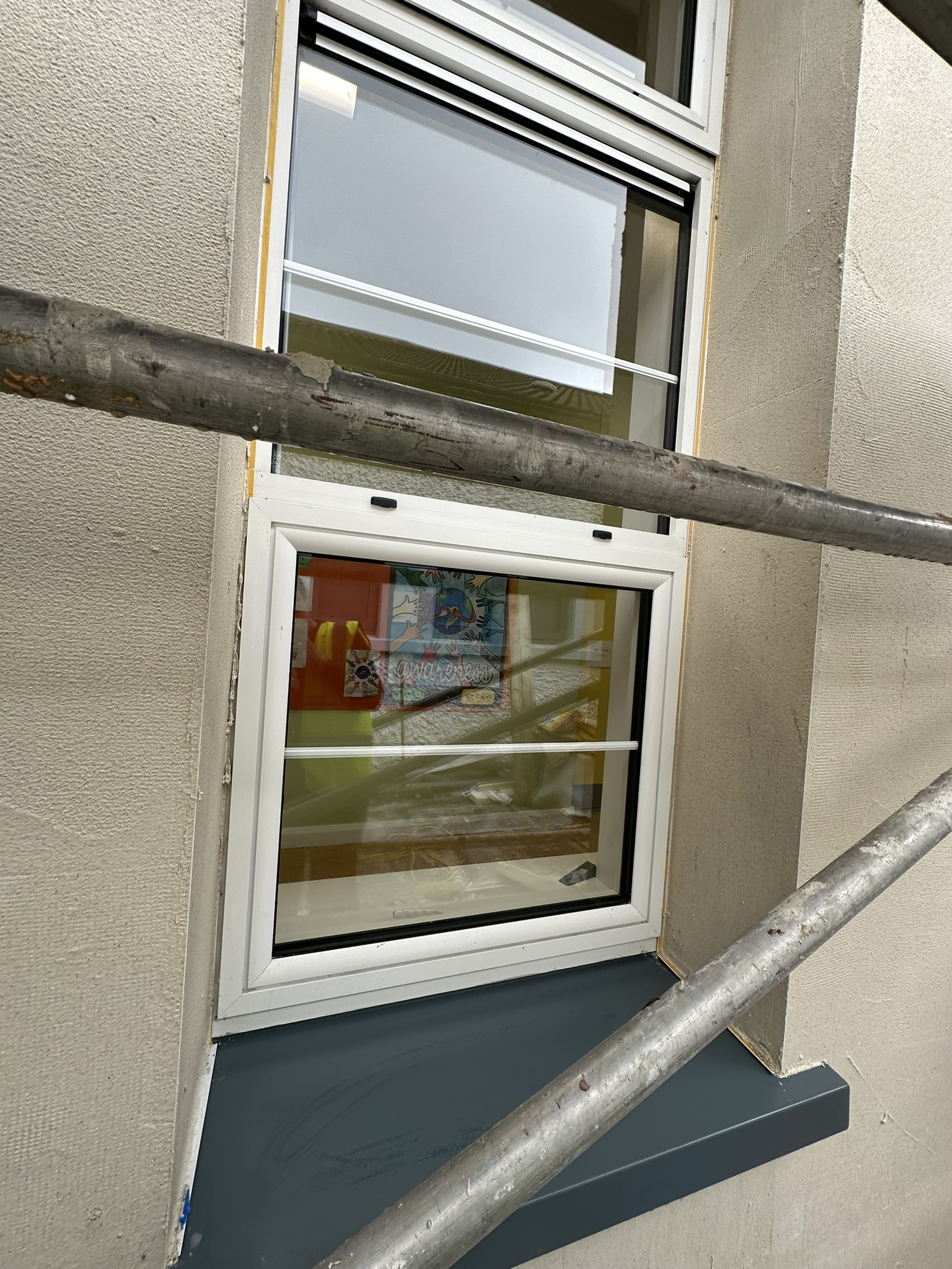 : School window cleaning with scaffold in place after construction