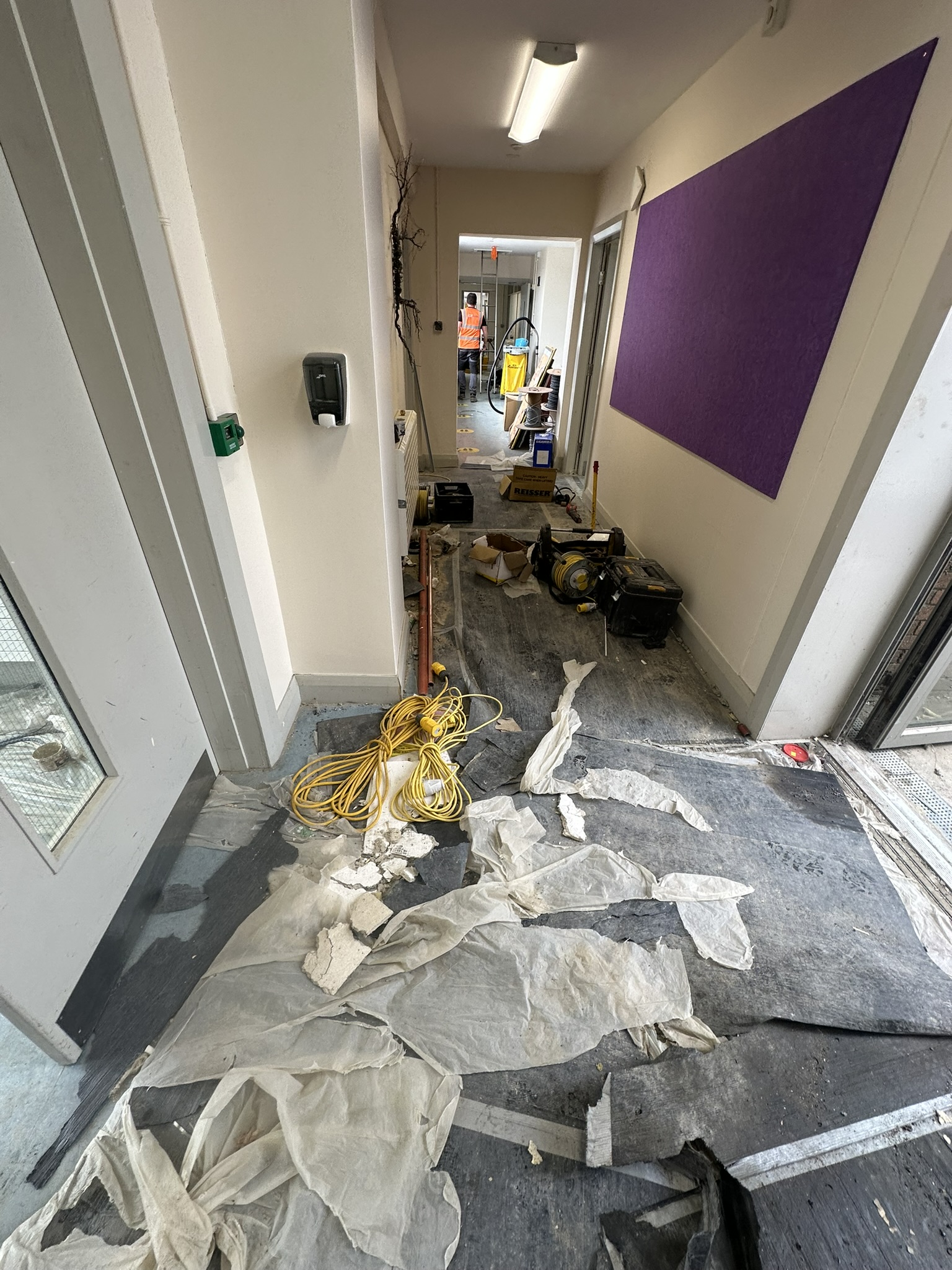 Construction debris filling school corridor before post construction clean