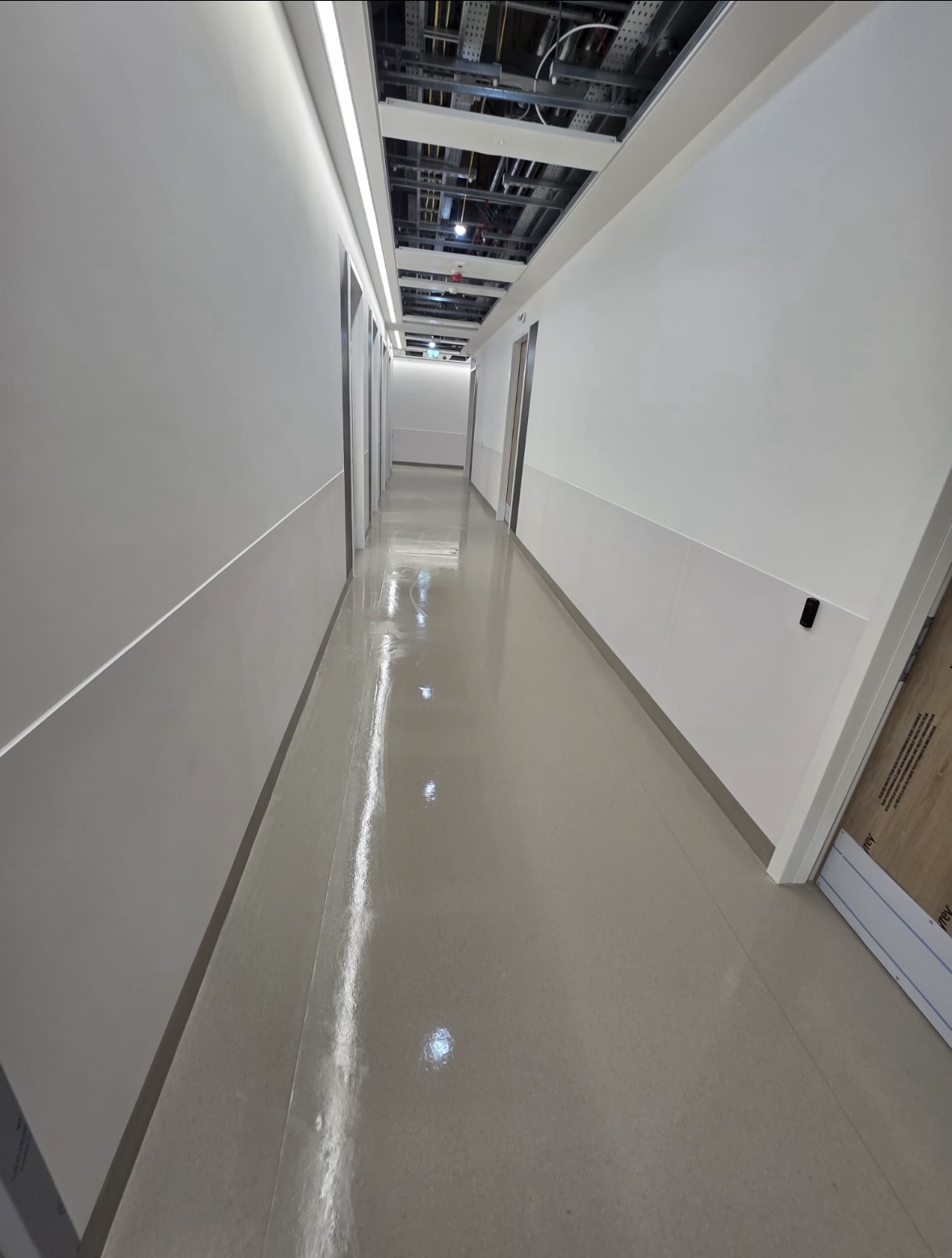 Long hospital corridor floor cleaned during builders clean St Vincent's Hospital