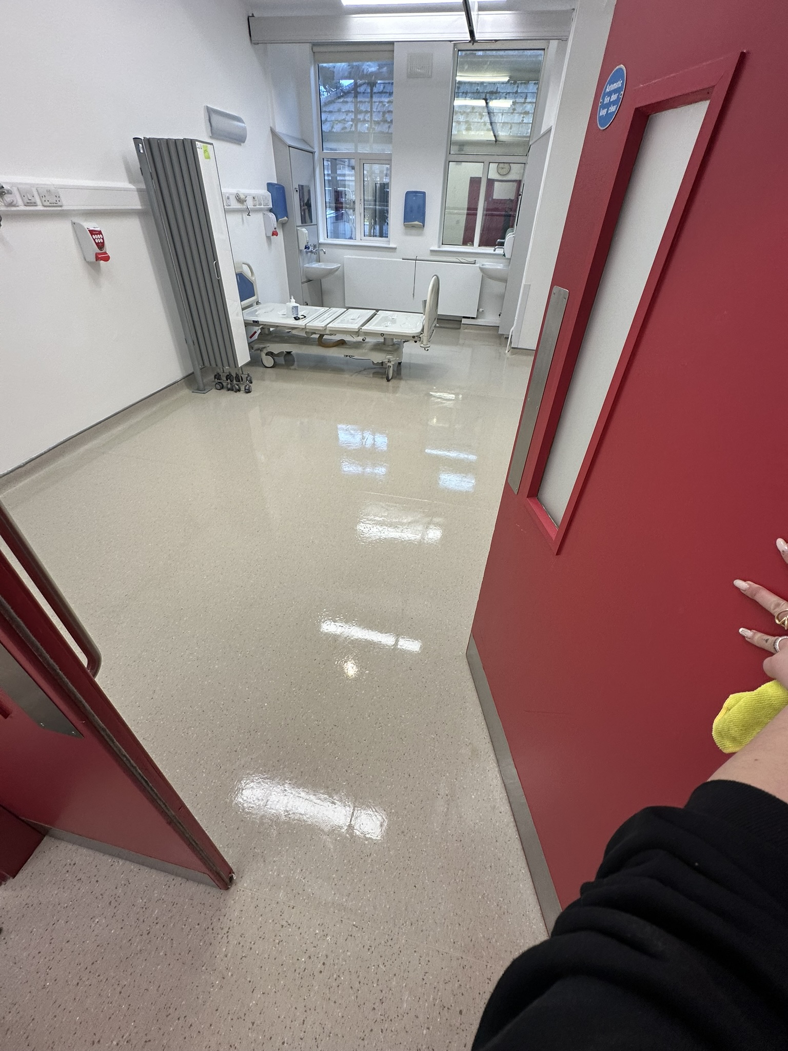Hospital patient room polished floor with cleaner wiping surfaces Baltinglass Community Hospital