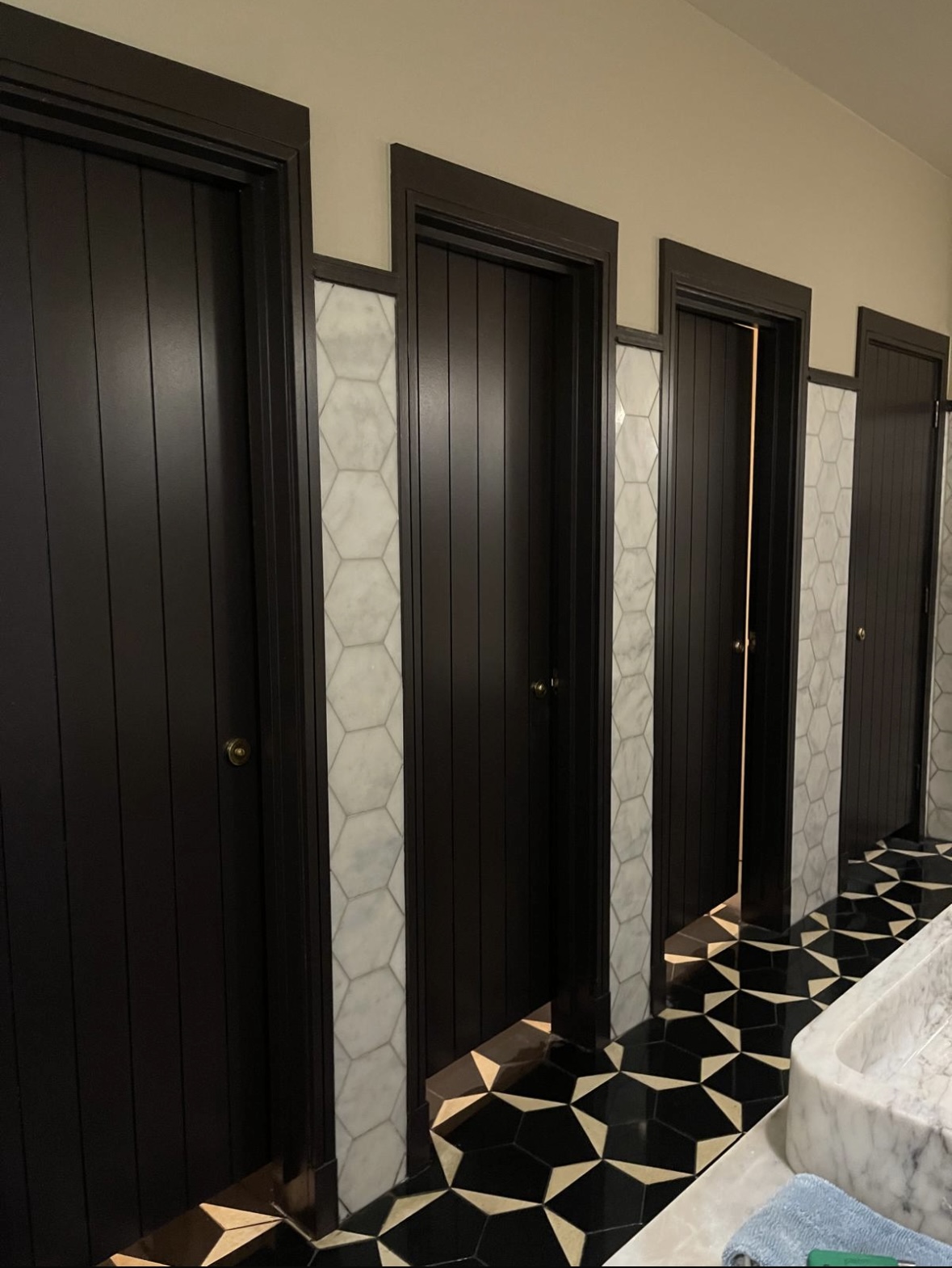 Toilet cubicles cleaned with patterned floor Sophie's Rooftop Dean Hotel