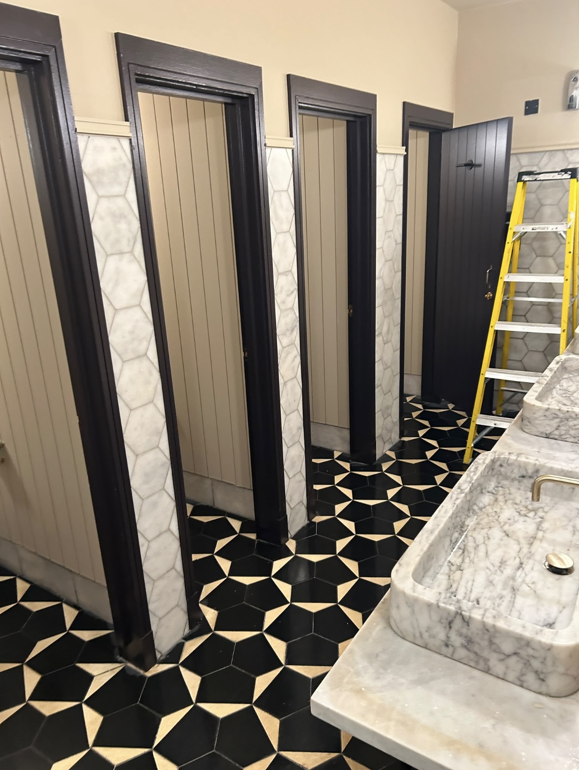 Toilet cubicles and marble sinks cleaned Sophie's Rooftop Dean Hotel