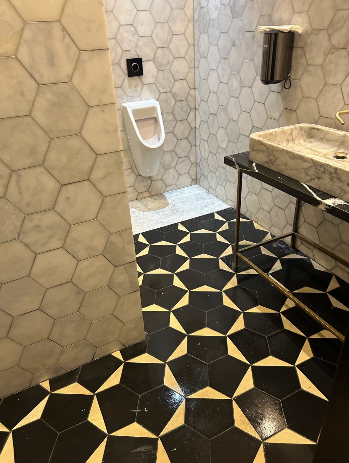 Marble washroom with urinal and sink cleaned after builders clean Sophie's Rooftop Dean Hotel