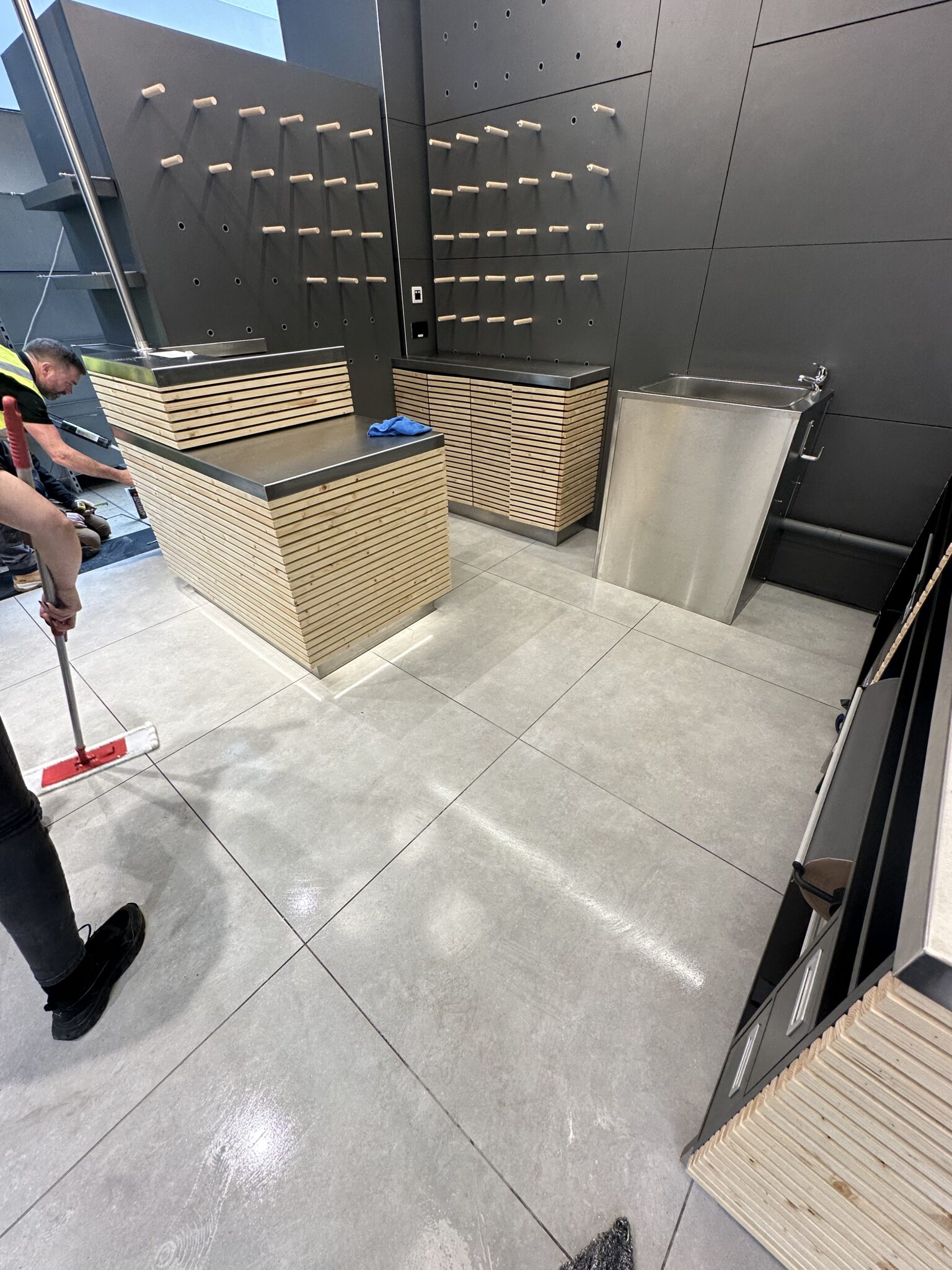 Mopping retail fit-out floor during post construction clean Dunnes Stores