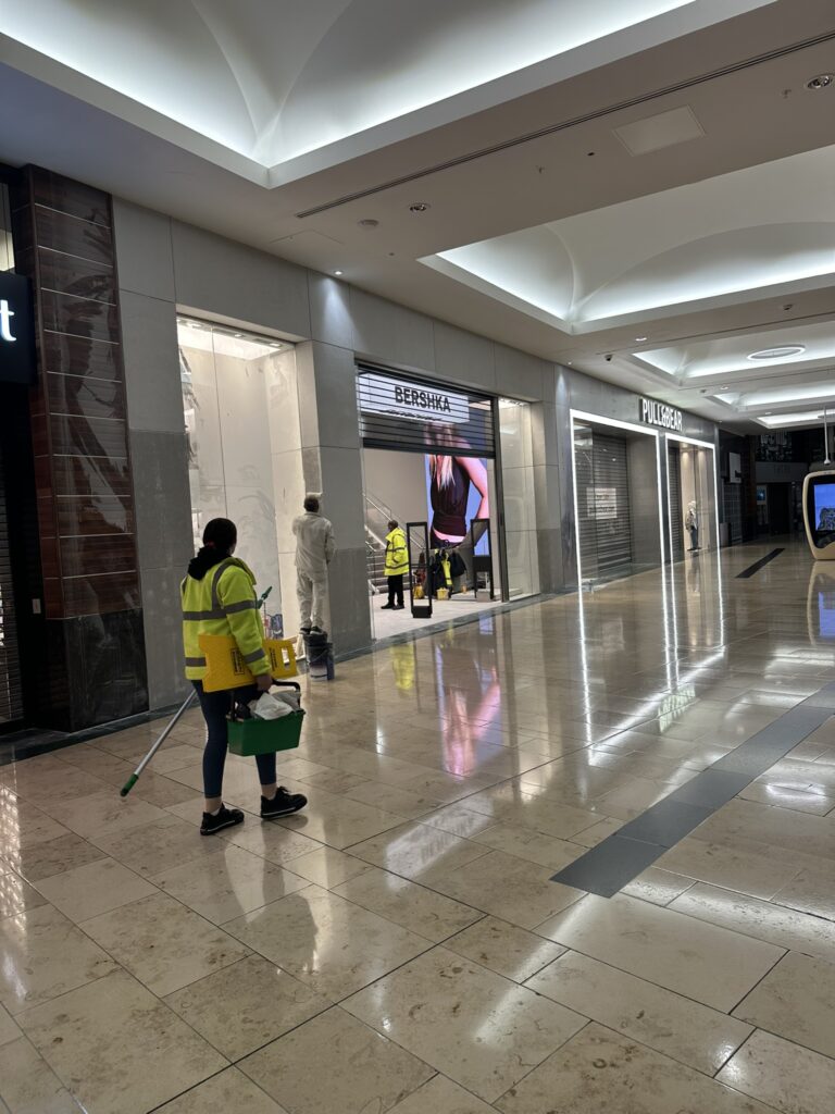 Retail fit-out cleaning team working on a shopfront in Dundrum, Dublin during post-construction cleaning before store handover.