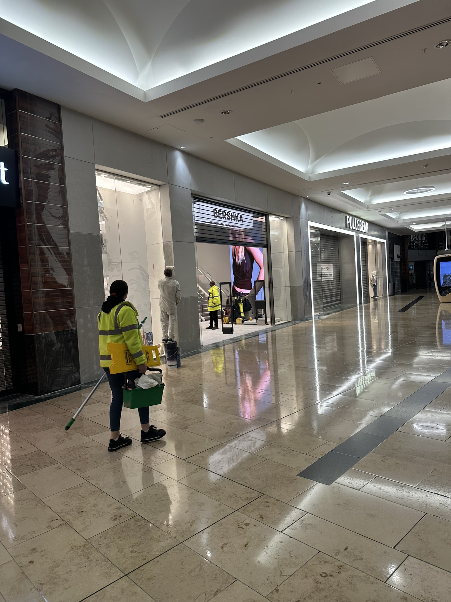Retail fit-out cleaning team working on a shopfront in Dundrum, Dublin during post-construction cleaning before store handover.