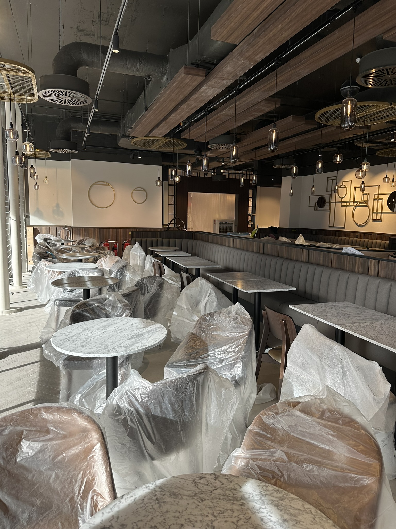 Dunnes Stores fit-out at Beacon Court, Sandyford during phased post-construction cleaning with newly installed furniture protected before final handover.