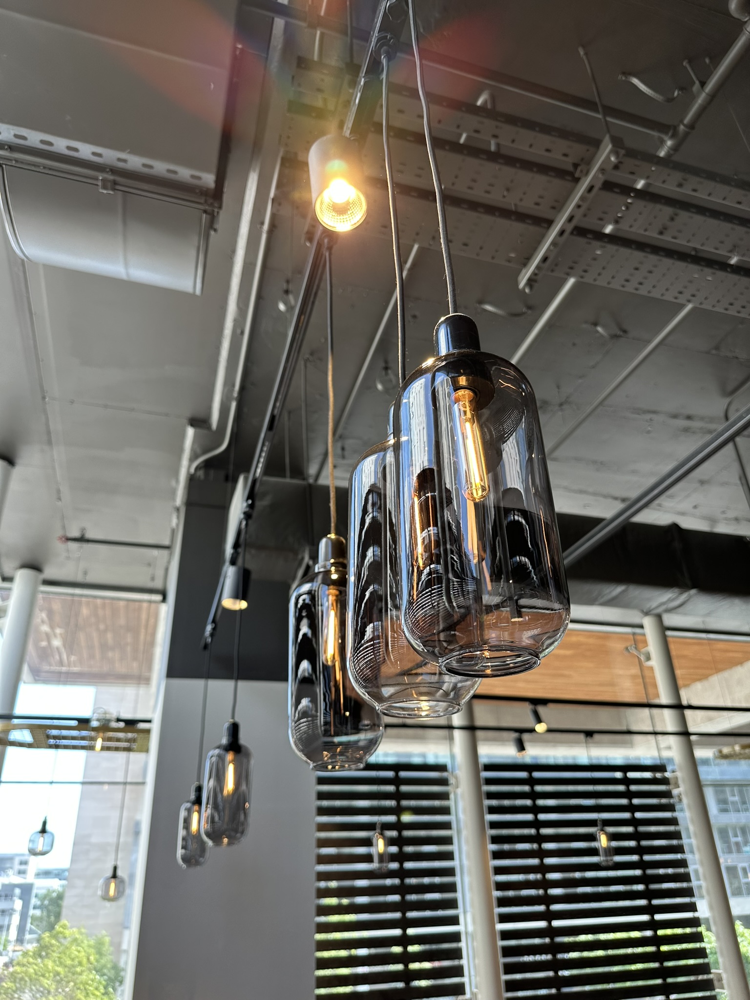 Clean pendant light fixtures following detailed post-construction cleaning at the Dunnes Stores fit-out in Beacon Court, Sandyford.