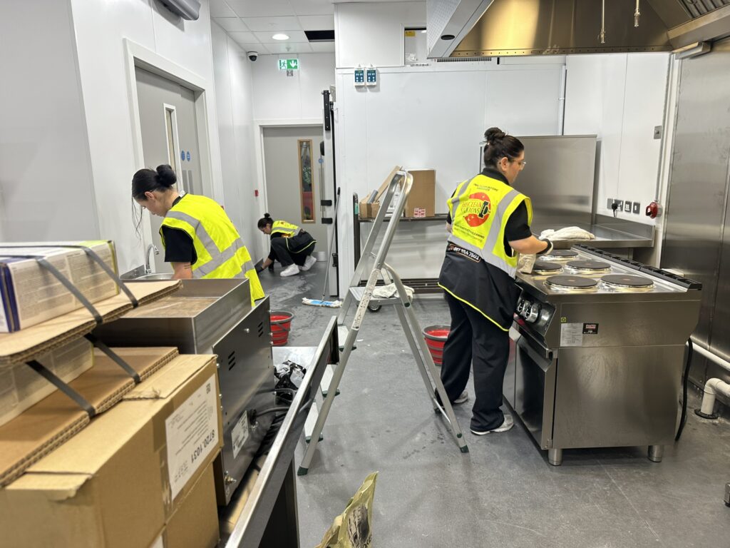 Hexaclean team carrying out post-construction cleaning of the commercial kitchen during the Dunnes Stores fit-out at Beacon Court, Sandyford.