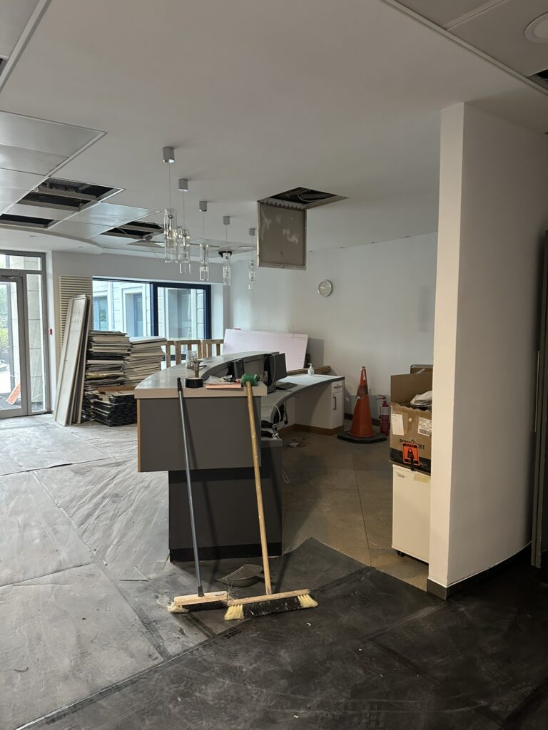 Office fit out reception before after builders cleaning showing construction dust and building materials in Dublin.