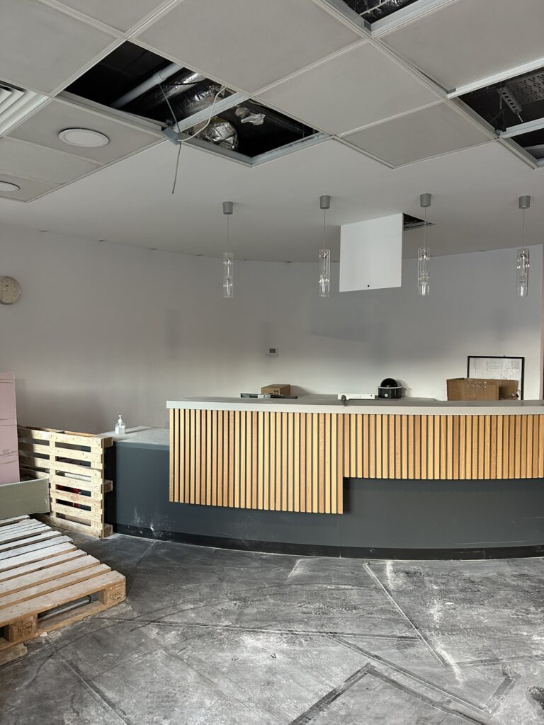 Office fit out before after builders cleaning with construction dust and unfinished reception area in Dublin.