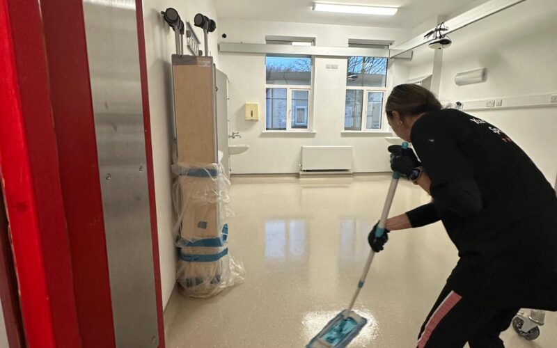 Professional construction site cleaning in Wicklow, showing detailed floor mopping in a medical facility after building works were completed.