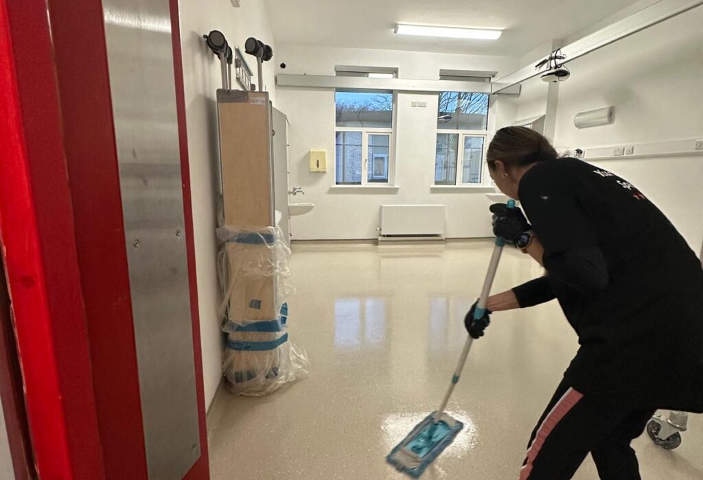 Professional construction site cleaning in Wicklow, showing detailed floor mopping in a medical facility after building works were completed.