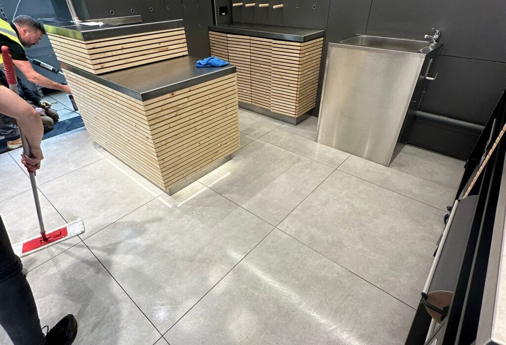 Professional sparkle cleaning being carried out on newly installed tiled floors as part of a post-construction cleaning project. This stage removes fine construction dust, grout residue and surface marks to ensure the commercial unit is inspection-ready and safe for handover.